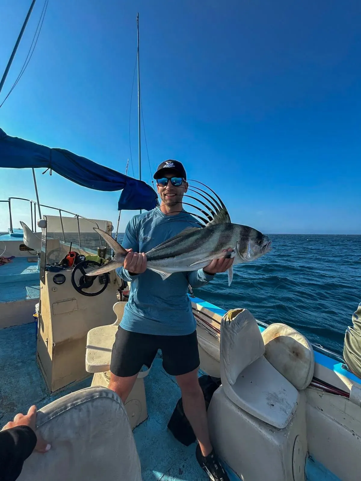 Angler with a roosterfish, late May 2025
