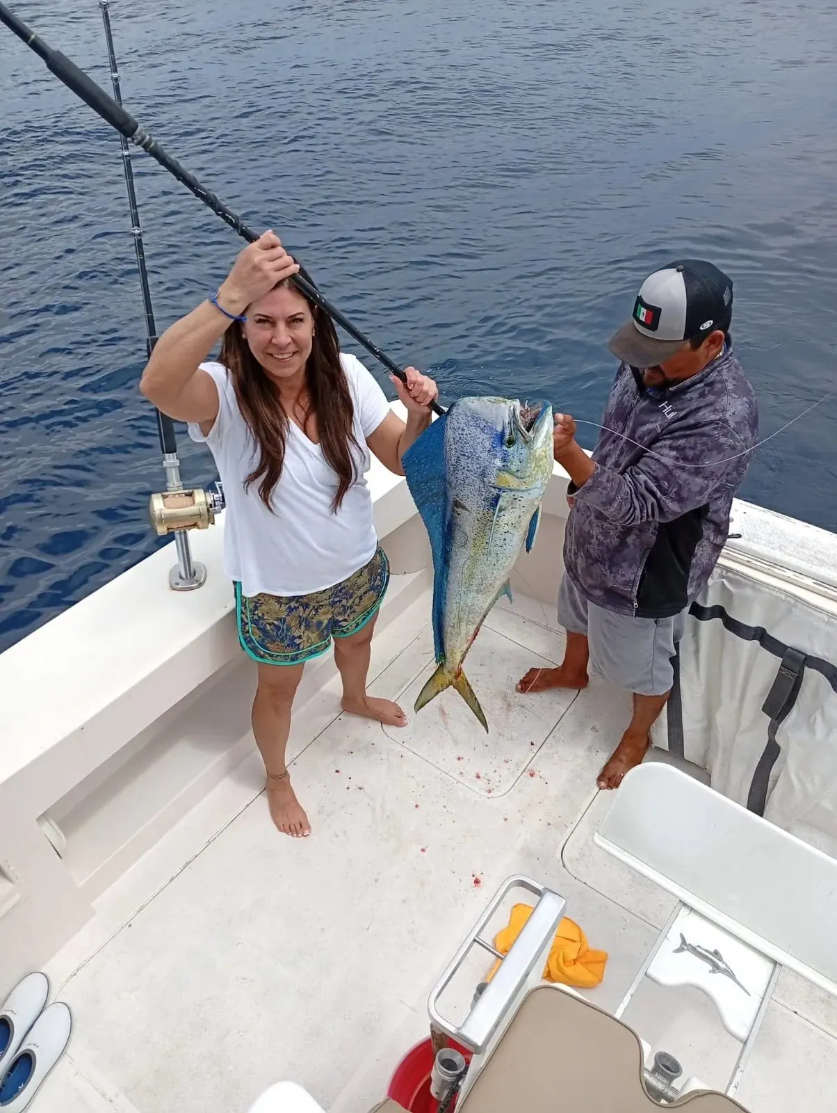 Angler and crew member with a dorado, early March 2026