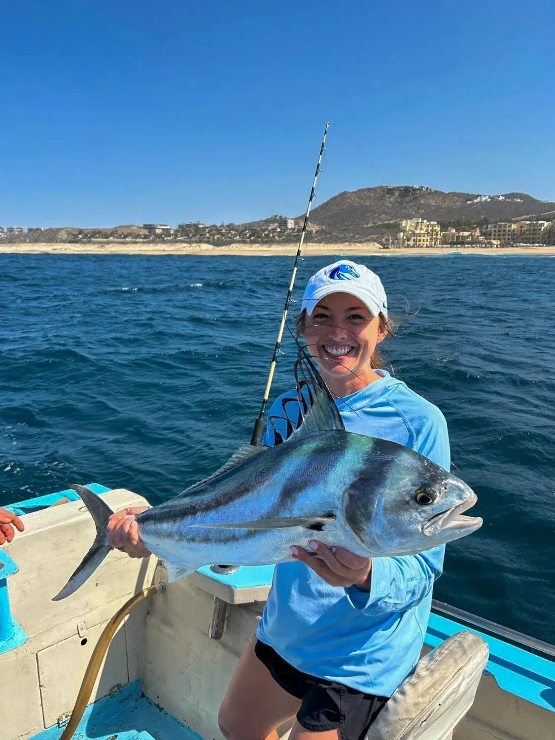 Angler with a roosterfish near the beach, late May 2025