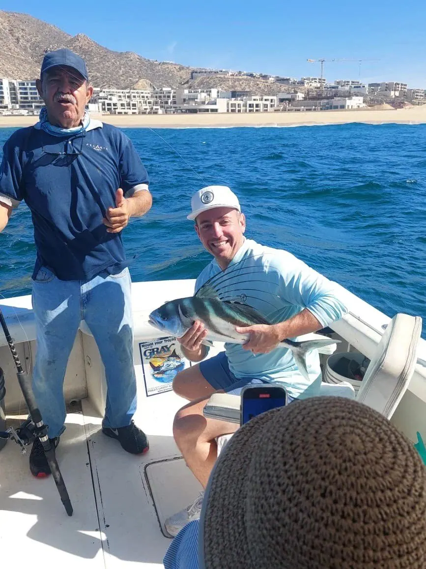 Anglers with a roosterfish near the beach, May 2025