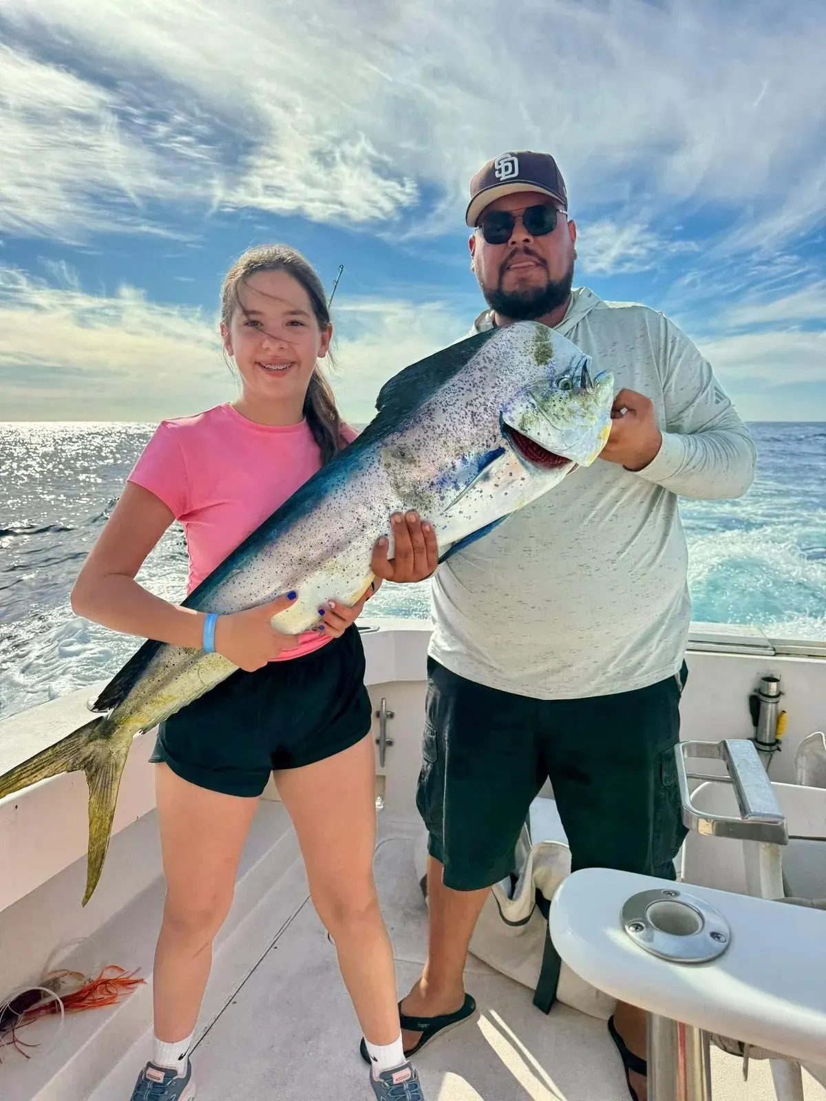 Father and daughter with a roosterfish, January 2026