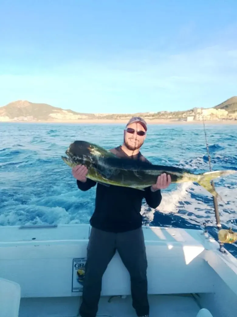 Angler with a dorado near the coast, December 2025