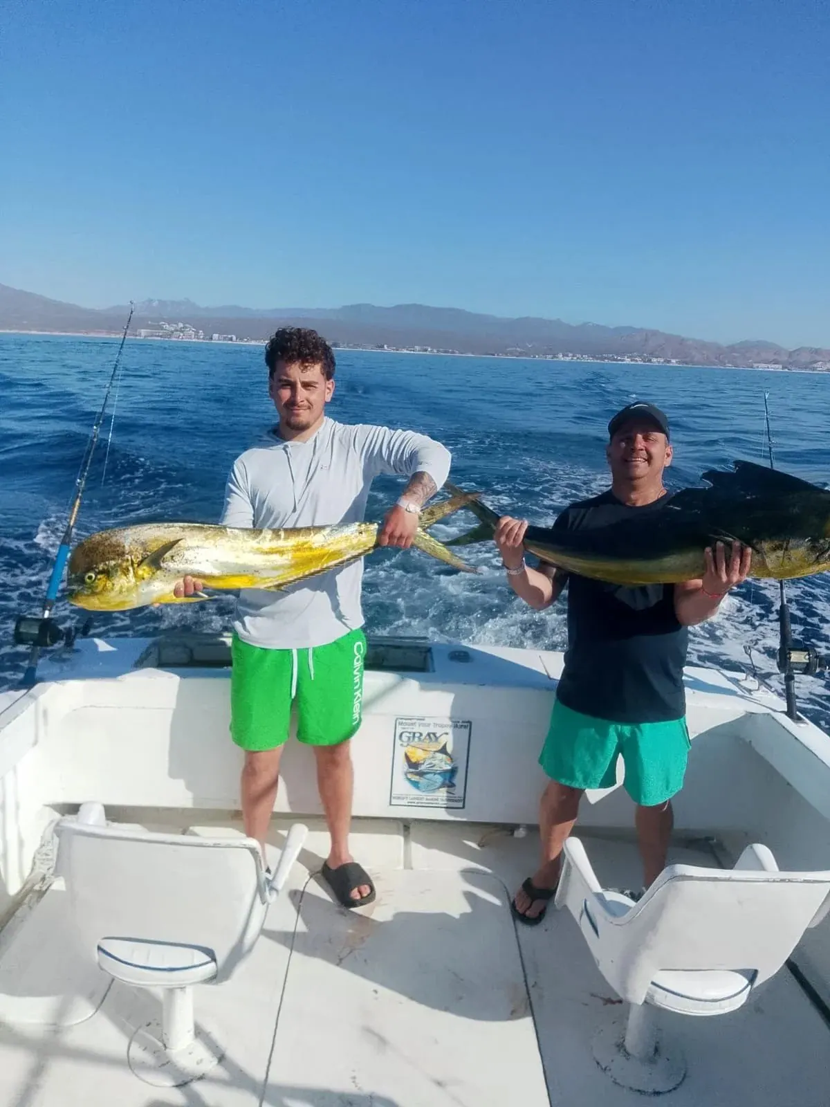 Two anglers with dorado, late March 2026