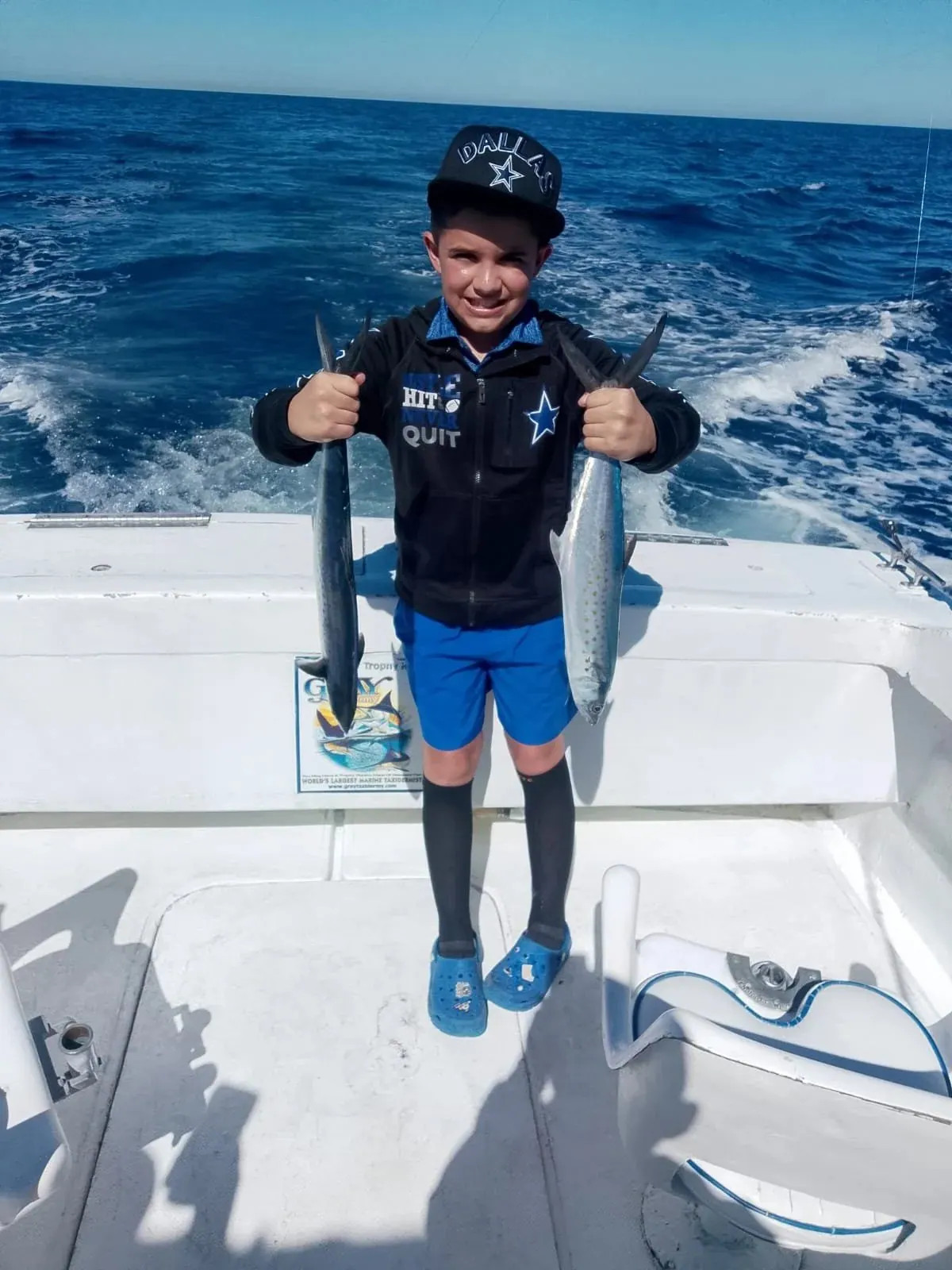 Young angler with two tunas, February 2026
