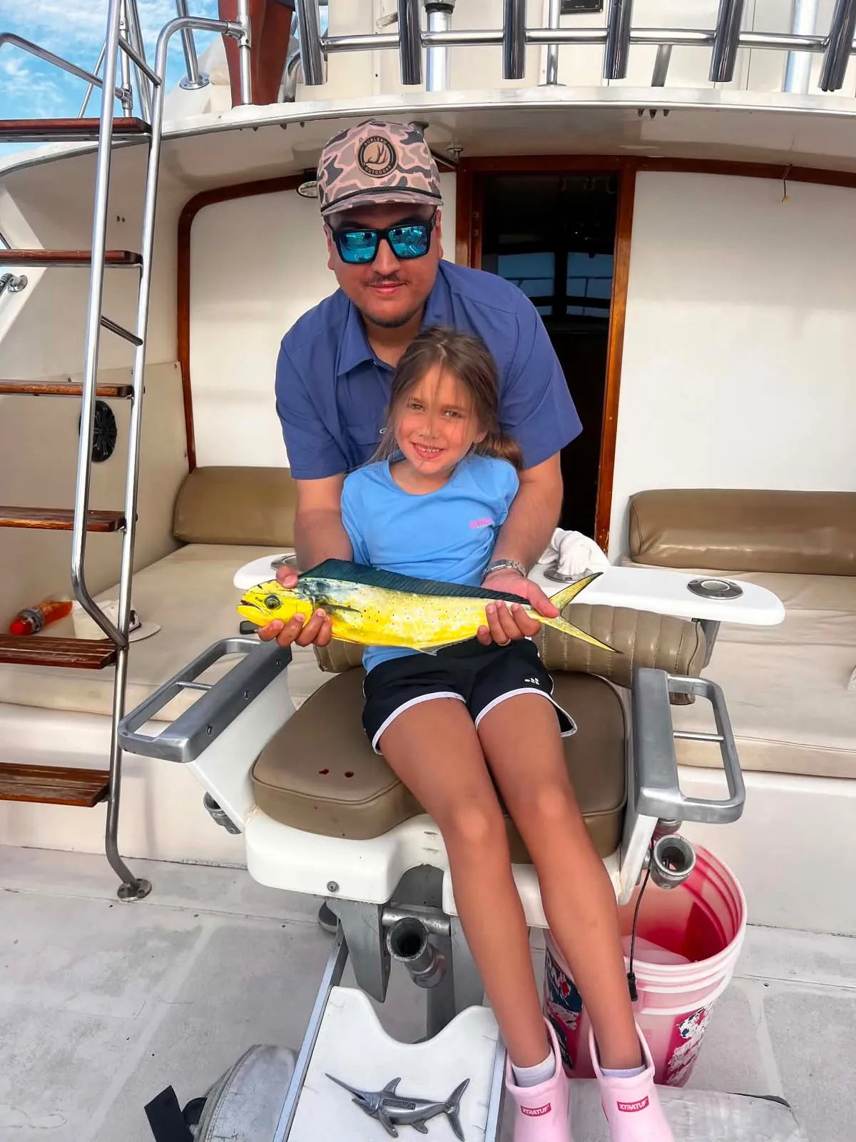 Girl in the fighting chair with her dorado, August 2026