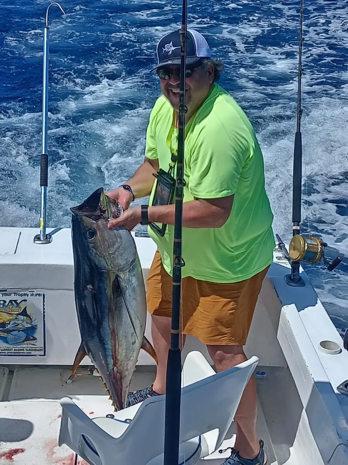 Angler with a yellowfin tuna, early July 2026