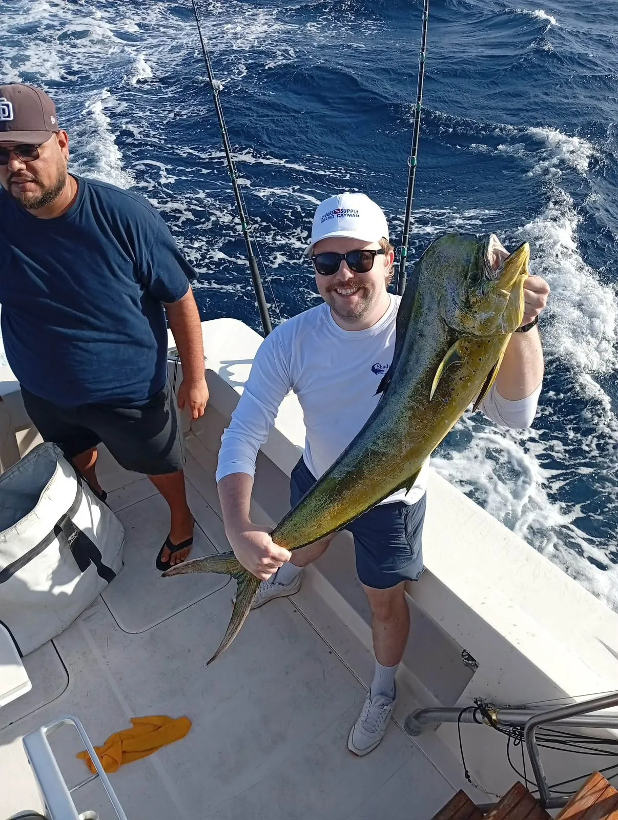 Angler with a bull dorado, late June 2026