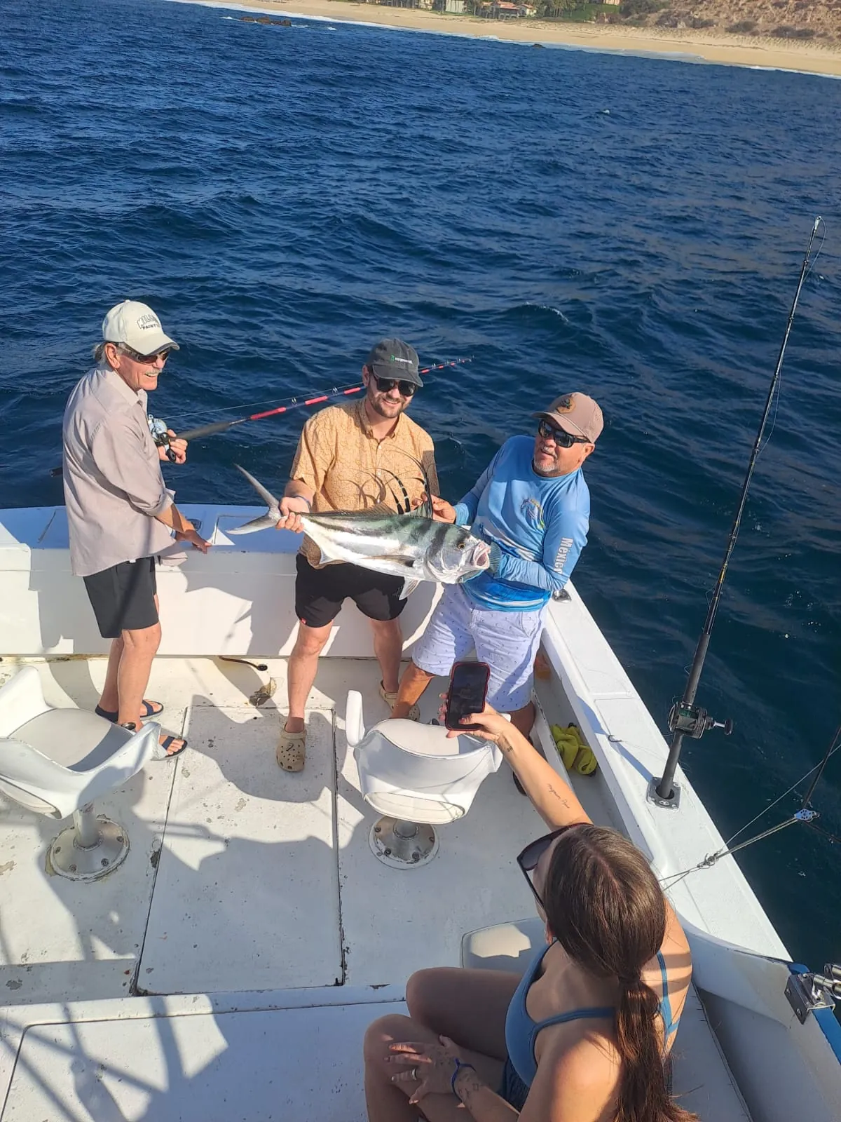 Anglers with a roosterfish caught near the beach, late June 2026